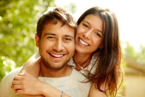Portrait of a happy couple laughing at camera sf oral surgery
