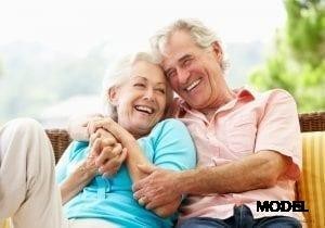 Older couple smiling sf oral surgery
