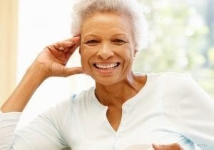 Smiling elderly woman in sunlight sf oral surgery